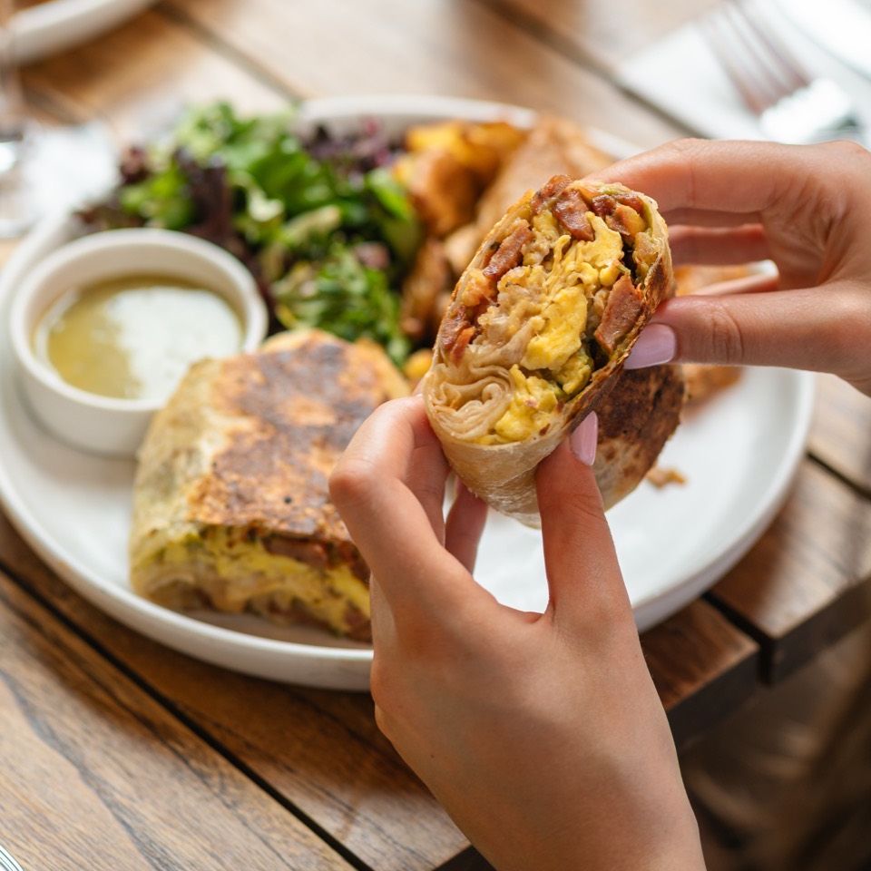 Breakfast burrito with eggs and bacon at Café Maud brunch