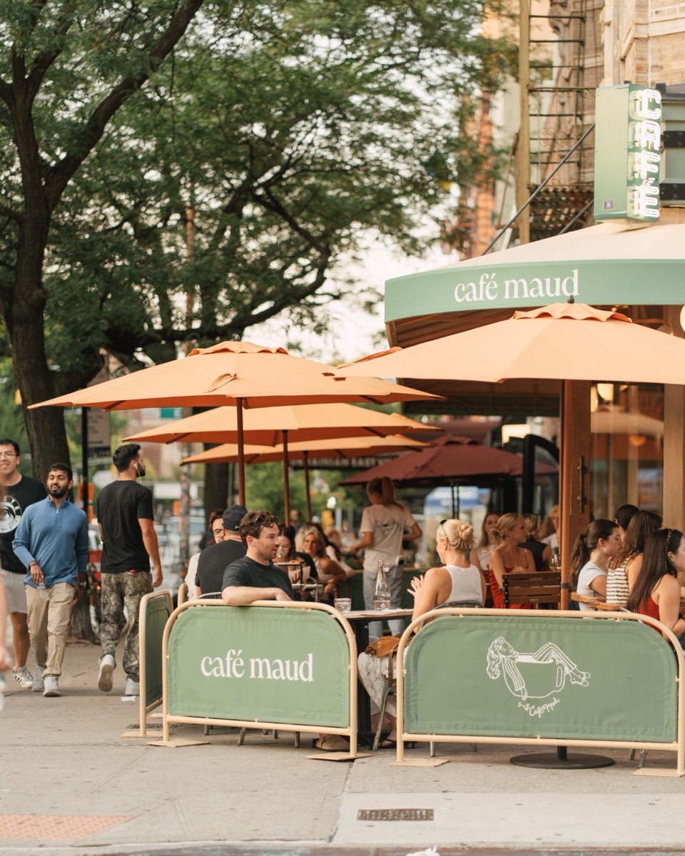 Café Maud East Village storefront on 2nd Ave, with outdoor seating under the awning