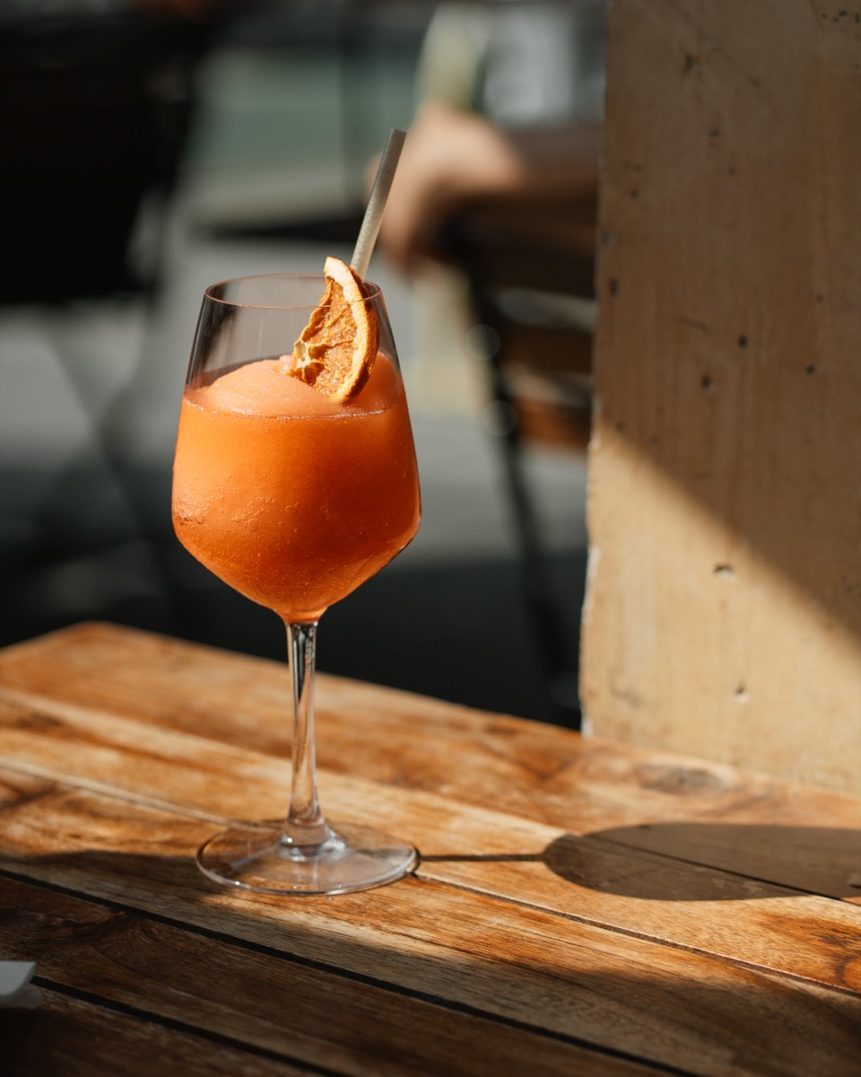 Frozen Aperol Spritz on a sunny outdoor table at Café Maud