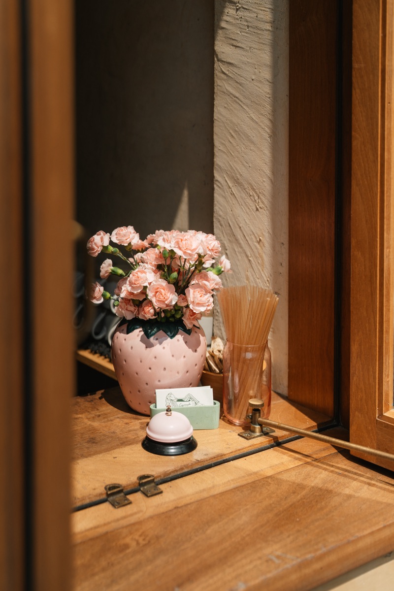 Inside Café Maud — guests at tables in the warm, welcoming dining room