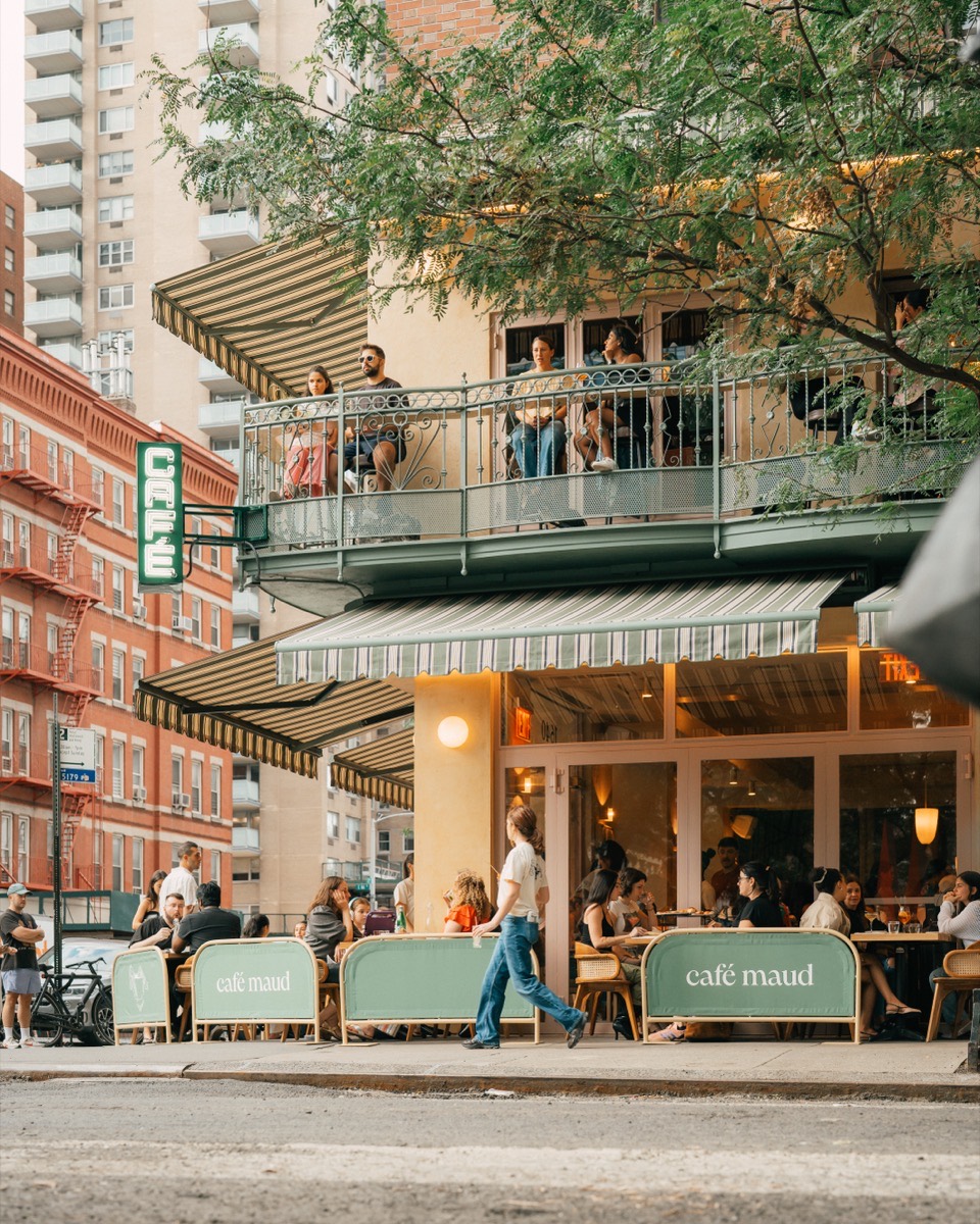 Café Maud Upper East Side storefront near 85th Street on 2nd Ave, with balcony and patio seating